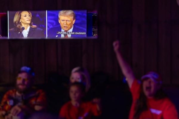 Tiana Robinson cheers at a Republican presidential debate watch party at Smyrna gun store and indoor shooting range in 2024. (Arvin Temkar/AJC)