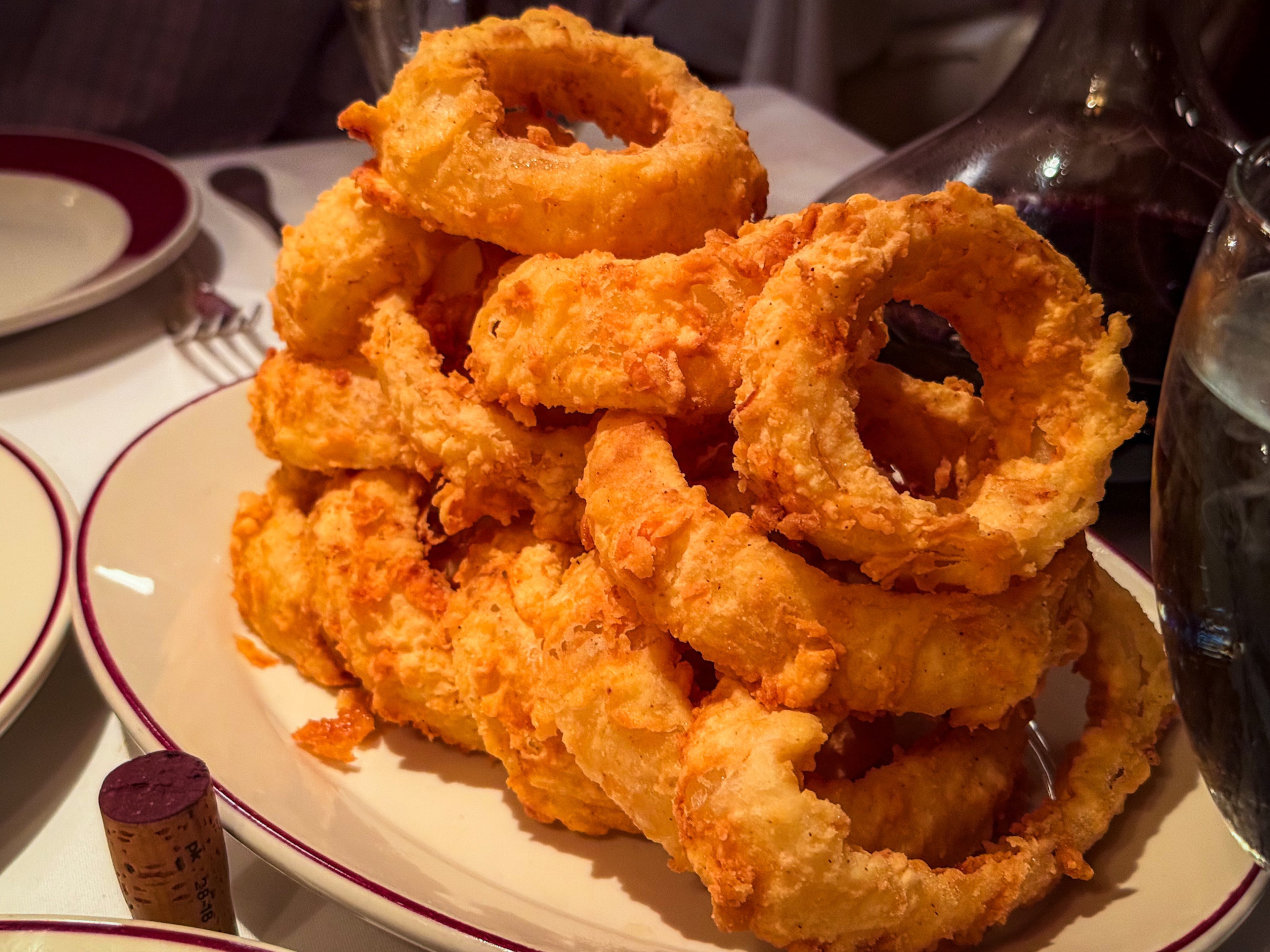 Enjoy a tower of oversized onion rings at Bones by yourself or share them with a friend. (Henri Hollis/AJC)