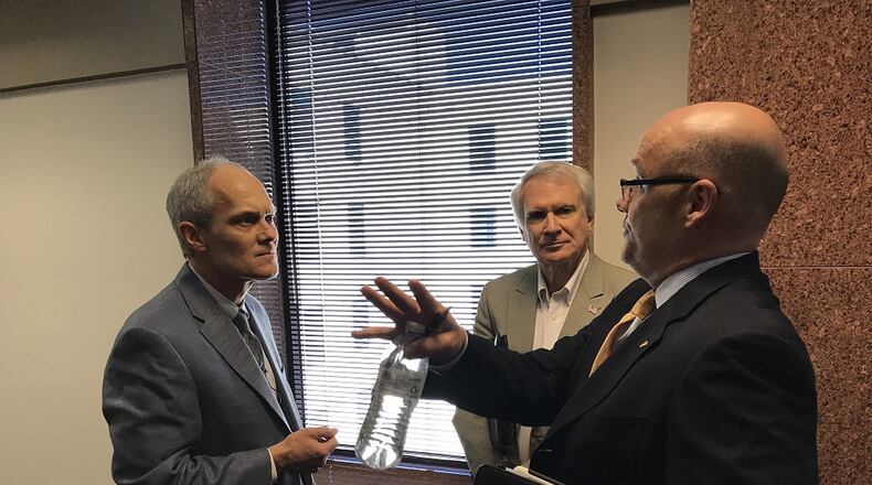 Decatur City Attorney Bryan Downs, left, in a heated exchanged with Immigration Enforcement Review Board member Phil Kent and board chairman Shawn Hanley, right. JEREMY REDMON/jredmon@ajc.com