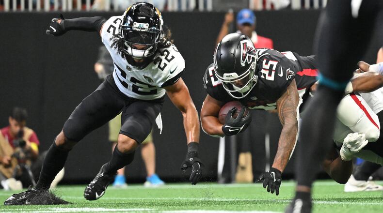 Falcons running back Tyler Allgeier (25) falls into the end zone for a touchdown during the second half of the final exhibition game at Mercedes-Benz Stadium on Saturday, Aug. 27, 2022. (Hyosub Shin / Hyosub.Shin@ajc.com)