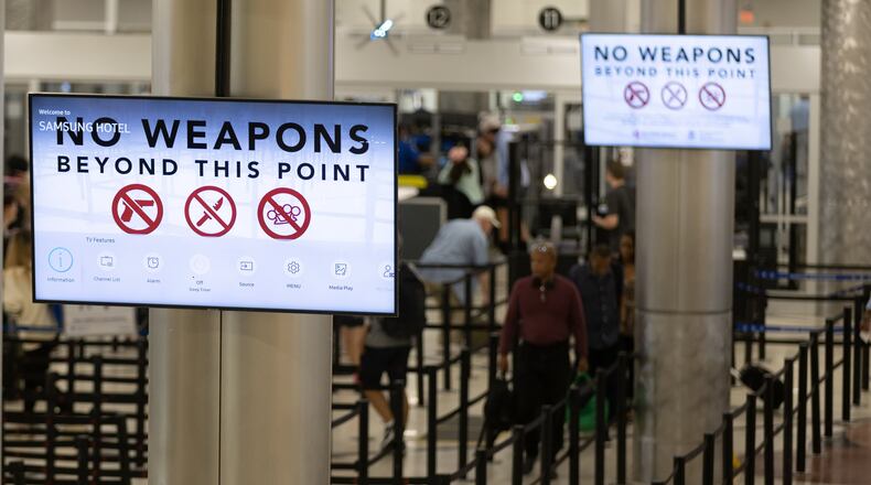 Passengers head through a security checkpoint at Hartsfield-Jackson International Airport in Atlanta on Friday, July 1, 2022. (AJC 2022)