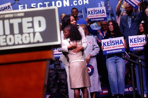 Democratic candidate for governor Keisha Lance Bottoms hugs her daughter Lincoln at a joint campaign rally with U.S. Sen. Jon Ossoff at the Tabernacle in Atlanta on May 31, 2026. (Arvin Temkar/AJC)