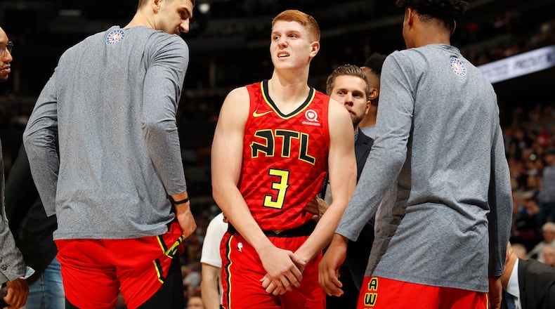 Atlanta Hawks guard Kevin Huerter holds his arm after an injury during the second half of the team's NBA basketball game agains the Denver Nuggets on Tuesday, Nov. 12, 2019, in Denver. Atlanta won 125-121. (AP Photo/David Zalubowski)