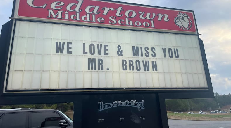 A sign outside Cedartown Middle School honors David Brown, a teacher killed in a crash Tuesday.