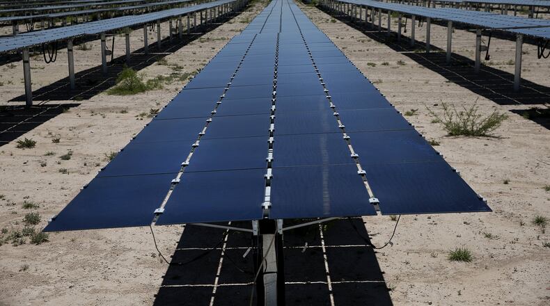In a file photo, solar panels soak up the sun at a West Texas facility under contract with Austin Energy.