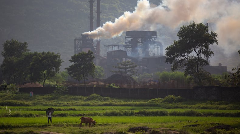 FILE- Smoke rises from a coal-powered steel plant at Hehal village near Ranchi, India, in eastern state of Jharkhand, Sept. 26, 2021. (AP Photo/Altaf Qadri, File)