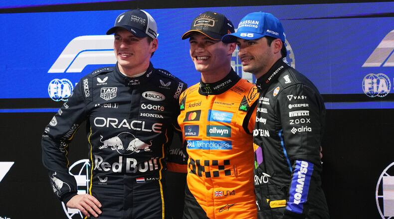 From left, second place finisher Red Bull driver Max Verstappen of the Netherlands, first place finisher McLaren driver Lando Norris of Great Britain, and third place finisher Williams driver Carlos Sainz of Spain pose for a photo after a qualifying session at the Formula One Las Vegas Grand Prix auto race, Friday, Nov. 21, 2025 in Las Vegas. (AP Photo/Eric Gay)