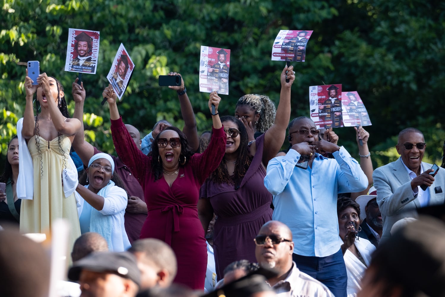 People react as students walk to the Morehouse College graduation Sunday, May 17, 2026. (Ben Gray for the AJC)