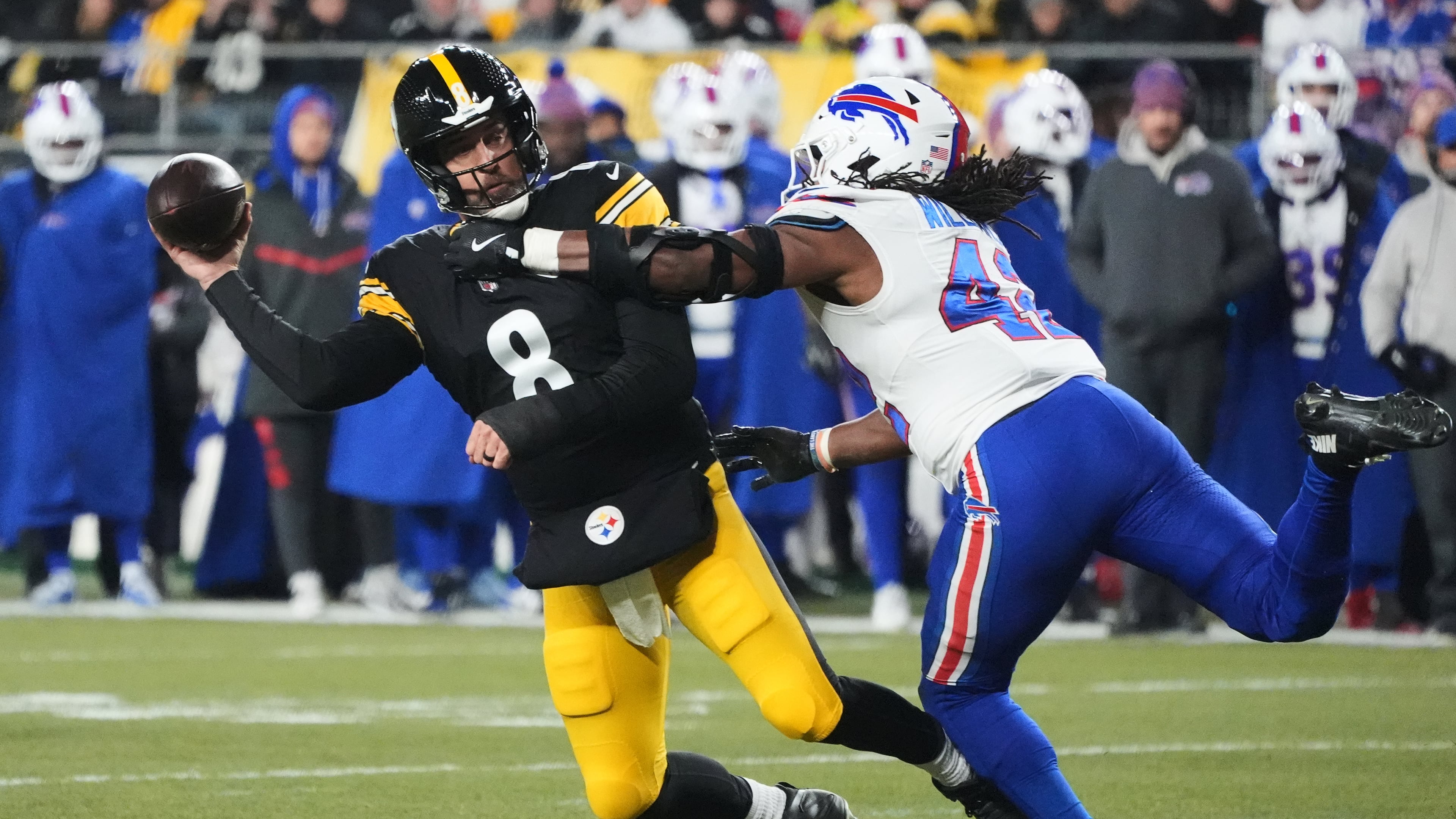 Pittsburgh Steelers quarterback Aaron Rodgers (8) throws against Buffalo Bills linebacker Dorian Williams (42) during the first half of an NFL football game Sunday, Nov. 30, 2025, in Pittsburgh. (AP Photo/Gene J. Puskar)
