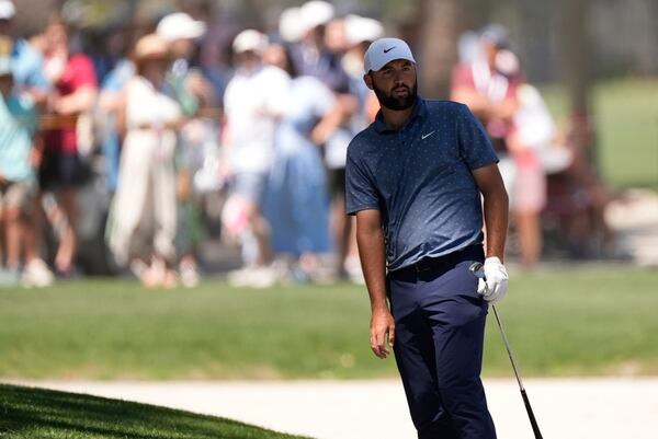 Scottie Scheffler watches his shot from the bunker on the second hole during the third round of the RBC Heritage golf tournament, Saturday, April 19, 2025, in Hilton Head Island, S.C. (AP Photo/Mike Stewart)