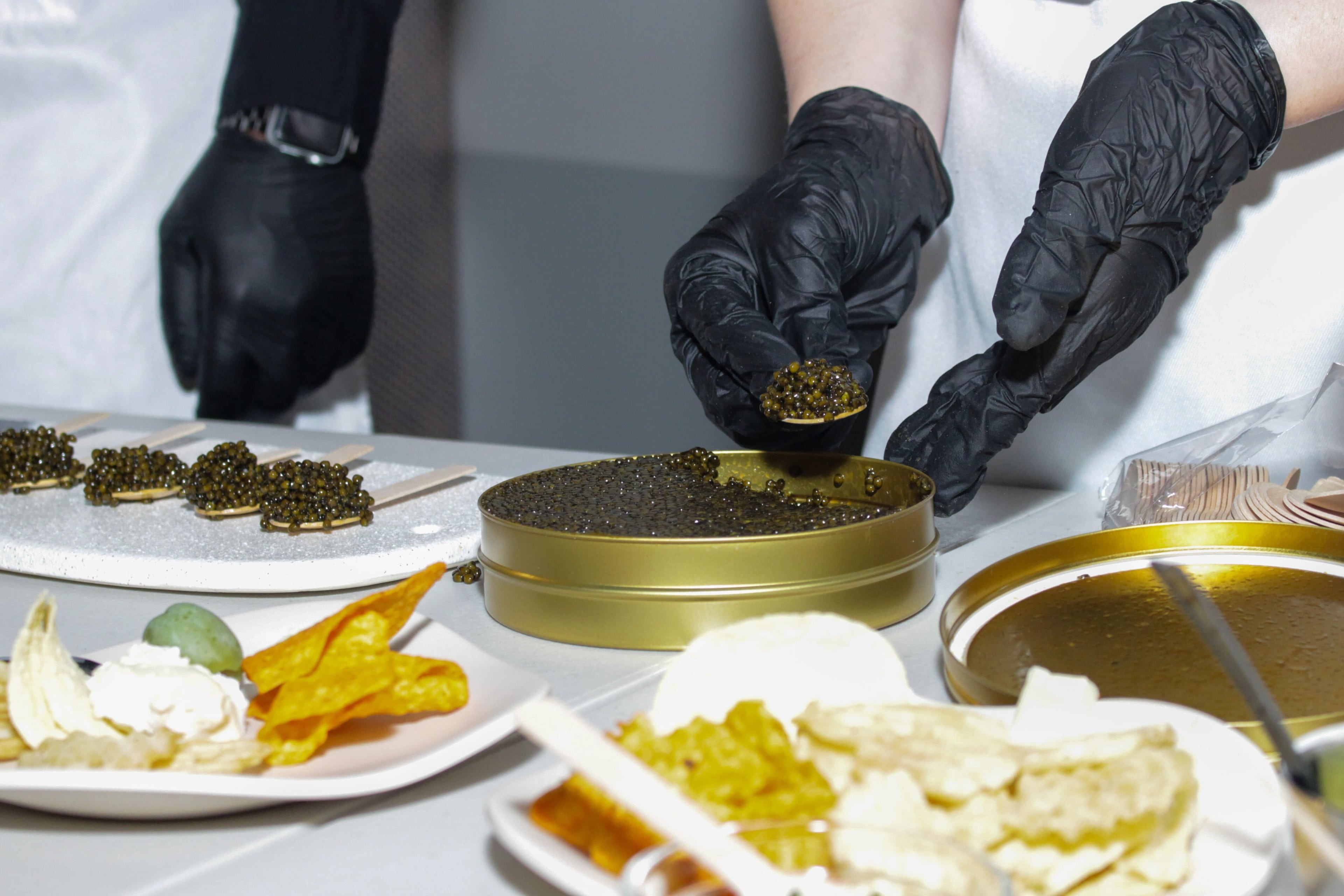 Creative Caviar staff members portion out bumps of caviar for a tasting event. (Courtesy of Eventful ATL)