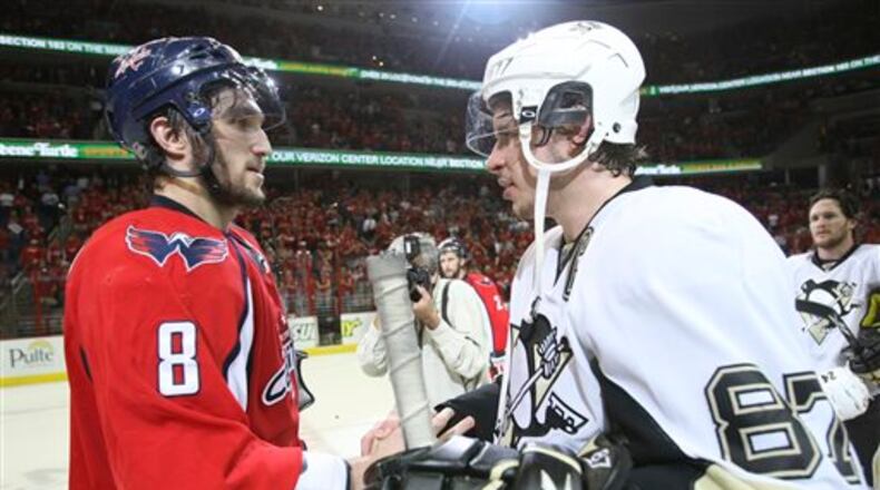 FILE - In this March 13, 2009 file photo, Washington Capitals' Alex Ovechkin (8), from Russia, shakes hands with Pittsburgh Penguins' Sidney Crosby (87) following Game 7 of an NHL hockey second-round playoff series, in Washington. After dispatching the New York Rangers in five games, Pittsburgh faces top-seed Washington in the second round, their ninth postseason clash but the first since 2009. (AP Photo/Bruce Bennett, Pool, File)