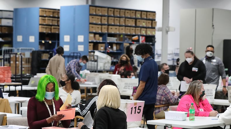 010521 LAWRENCEVILLE: Election workers sort provisional ballots during a flurry of activity on election night at the Beauty P. Baldwin Voter Registrations and Elections Building on Tuesday night, Jan. 5, 2021, in Lawrenceville. Curtis Compton / Curtis.Compton@ajc.com”