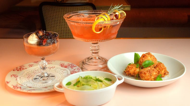 This menu assembled by Jeb Aldrich, executive chef at Tiny Lou’s, would be perfect for a New Year’s Eve dinner: Dark Chocolate Champagne Pot de Crème with Vanilla Chantilly and Macerated Blackberries (left), New England Shellfish Chowder (front center), Cranberry Countdown Punch (rear center) and Crab Beignets (right). STYLING BY JEB ALDRICH / CONTRIBUTED BY CHRIS HUNT PHOTOGRAPHY