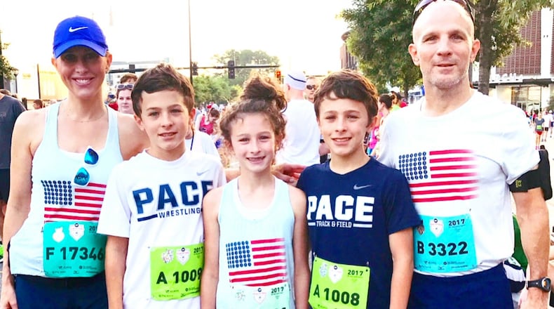 The portrait of a family at the finish line: (From left) Emily Giffin, children George, Harriet, Edward and husband Buddy Blaha. (Photo courtesy Emily Giffin)