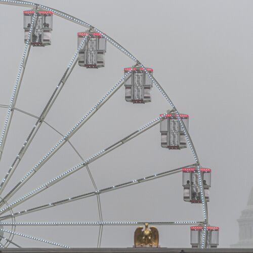 The U.S. Capitol is seen through fog behind the ferris wheel at the Great American State Fair on the National Mall, Sunday June 28, 2026, in Washington. (AP Photo/Jen Golbeck)