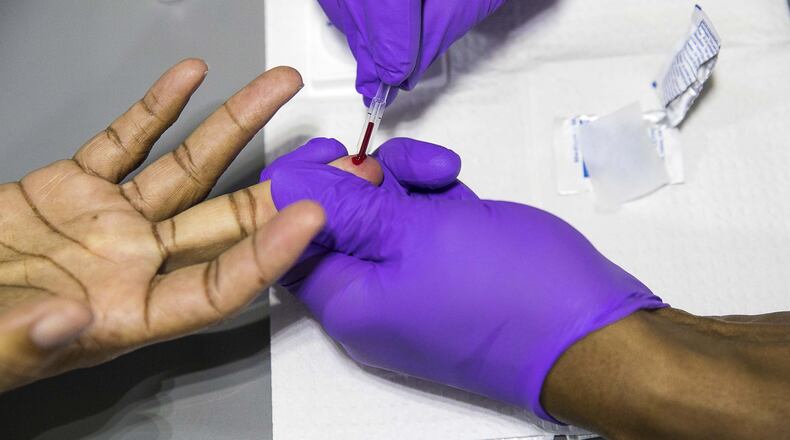 Bible Way Ministries Pastor Monte Norwood gets his blood drawn while being tested for HIV/AIDs in the Aids Healthcare Foundation mobile testing bus at Bible Gateway Ministries in Atlanta’s Norwood Manor neighborhood, Wednesday, December 11, 2019. The results from the test are completed within minutes.