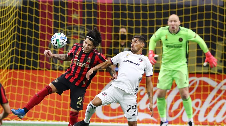 092320 Atlanta: Atlanta United defender Franco Escobar (from left) takes it away from FC Dallas forward Franco Jara in front of the goal with goalkeeper Brad Guzan looking on during the second half in a MLS soccer match on Wednesday, Sept. 23, 2020 in Atlanta.   “Curtis Compton / Curtis.Compton@ajc.com”