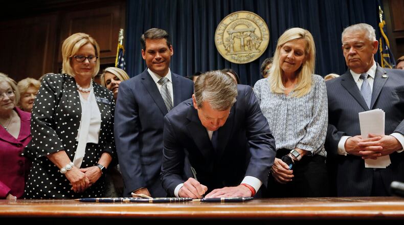 Surrounded by supporters of the bill, including Sen. Renee Unterman (from left), R - Buford, Lt. Gov. Geoff Duncan, First Lady Marty Kemp, and House Speaker David Ralston, Gov. Brian Kemp signed HB 481, the "heartbeat bill", on Tuesday, setting the stage for a legal battle as the state attempts to outlaw most abortions after about six weeks of pregnancy. The bill, sponsored by Rep. Ed Setlzer, R-Acworth, and carried in the Senate by Sen. Renee Unterman, R - Buford, outlaws most abortions once a doctor can detect a fetus' heartbeat - usually around six weeks of pregnancy. Bob Andres, bandres@ajc.com