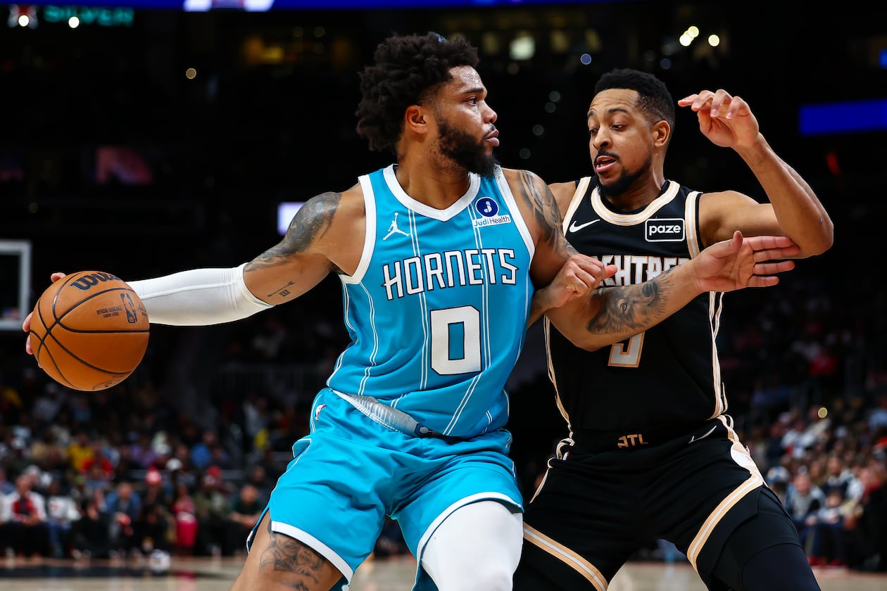 Charlotte Hornets forward Miles Bridges dribbles against Atlanta Hawks guard CJ McCollum, right, during the first half of an NBA basketball game, Saturday, Feb. 7, 2026, in Atlanta. (Colin Hubbard/AP)