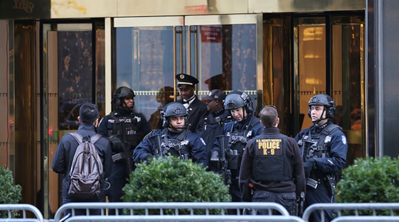 In this Nov. 17, 2016 file photo, New York City Police Department officers stand at the front entrance of Trump Tower in New York. The new federal spending bill would allocate $61 million to reimburse primarily New York City and Palm Beach County for police overtime and other local expenses related to securing President Donald Trump and his family at Trump Tower and Mar-a-Lago.