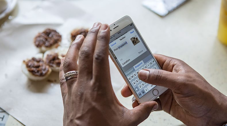 File photo of a woman on her phone.