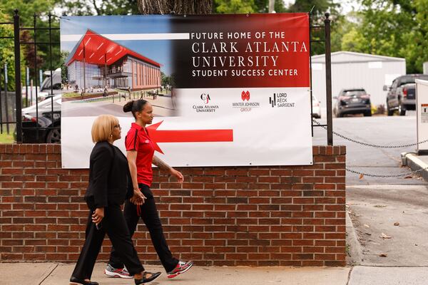 People walk past a sign advertising the future Student Success Center at Clark Atlanta University on Thursday, May 15, 2025. (Natrice Miller/AJC)