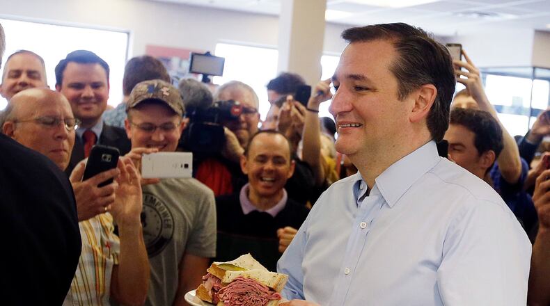 FILE - In this April 21, 2016 file photo, Republican presidential candidate, Sen. Ted Cruz, R-Texas, holds his sandwich during a campaign stop at Shapiro's Delicatessen, in Indianapolis. (AP Photo/Darron Cummings, File)