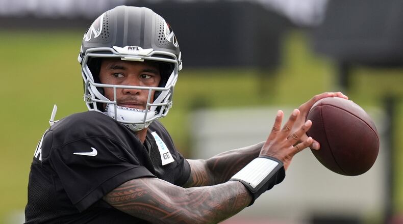 Atlanta Falcons quarterback Tua Tagovailoa (1) works out during an NFL training camp, Friday, Aug. 7, 2026, in Flowery Branch, Ga. (AP Photo/Mike Stewart)