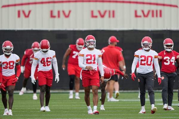 Kansas City Chiefs players warm up before the NFL football team's practice Tuesday, June 17, 2025, in Kansas City, Mo. (AP Photo/Charlie Riedel)