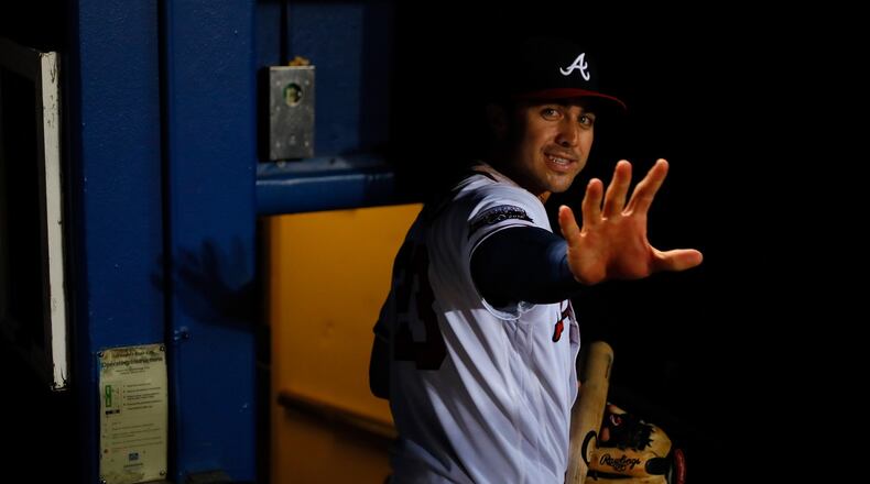 Chase d’Arnaud waves as he leaves the dugout after giving the Braves a 13-inning win over the Reds. (Photo by Kevin C. Cox/Getty Images)