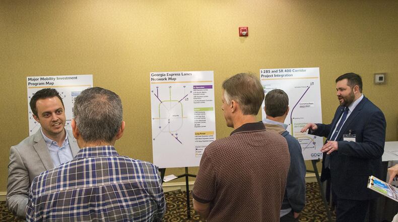 Residents listen to Georgia Department of Transportation consultants during an information meeting Tuesday in Doraville. GDOT is hosting a series of community meetings about its plans to add toll lanes to the top end of I-285. (Alyssa Pointer/alyssa.pointer@ajc.com) —
