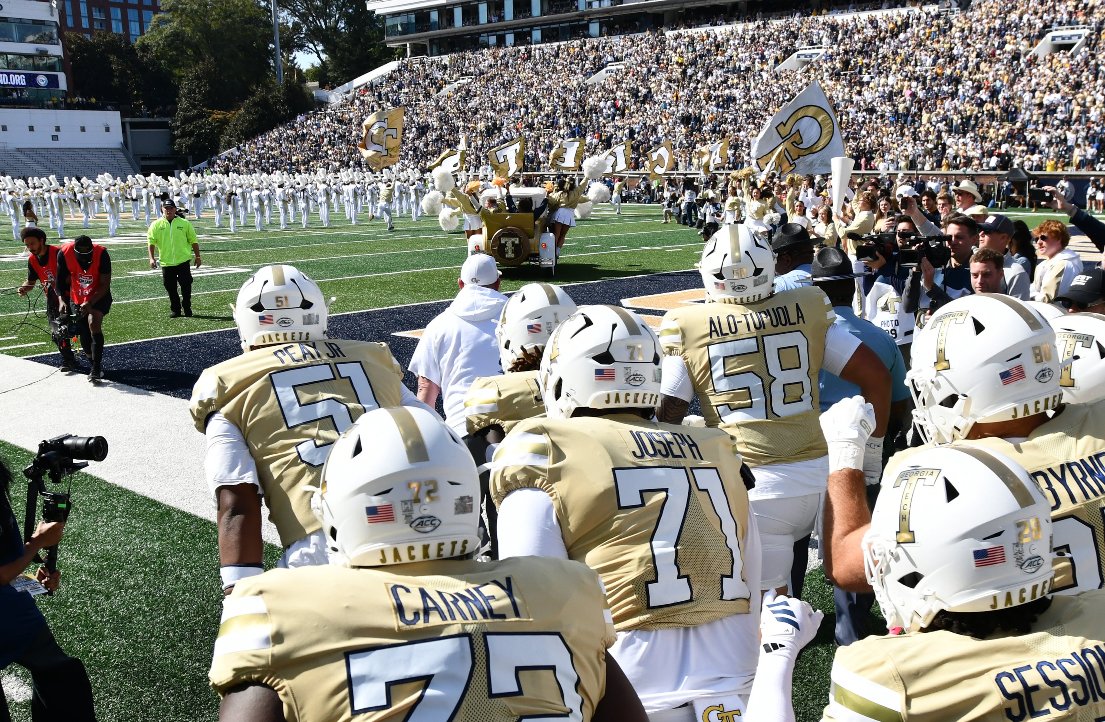 Georgia Tech's Ramblin' Wreck leads the band, cheerleaders, Buzz, players, and coaches before an NCAA college football game against Syracuse at Bobby Dodd Stadium, Saturday, October 25, 2025 in Atlanta. (Hyosub Shin / AJC)