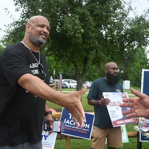 Harry Dunn, former U.S. Capitol police officer and candidate for U.S. Congress greets a voter Tuesday, June 23, 2026, in Upper Marlboro, Md. (AP Photo/Gail Burton)