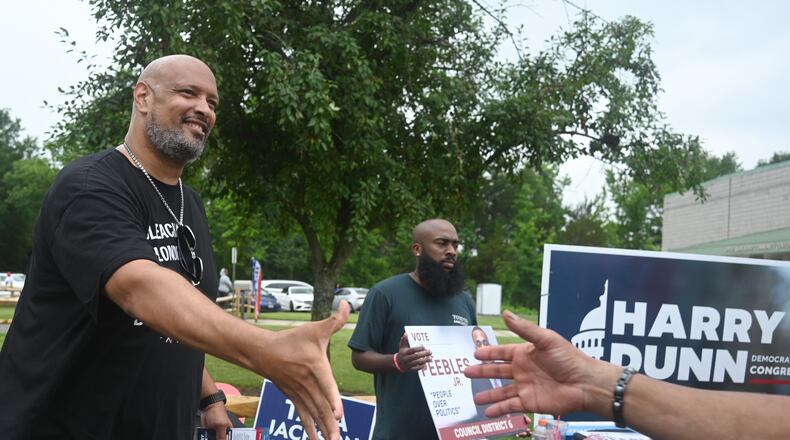 Harry Dunn, former U.S. Capitol police officer and candidate for U.S. Congress greets a voter Tuesday, June 23, 2026, in Upper Marlboro, Md. (AP Photo/Gail Burton)