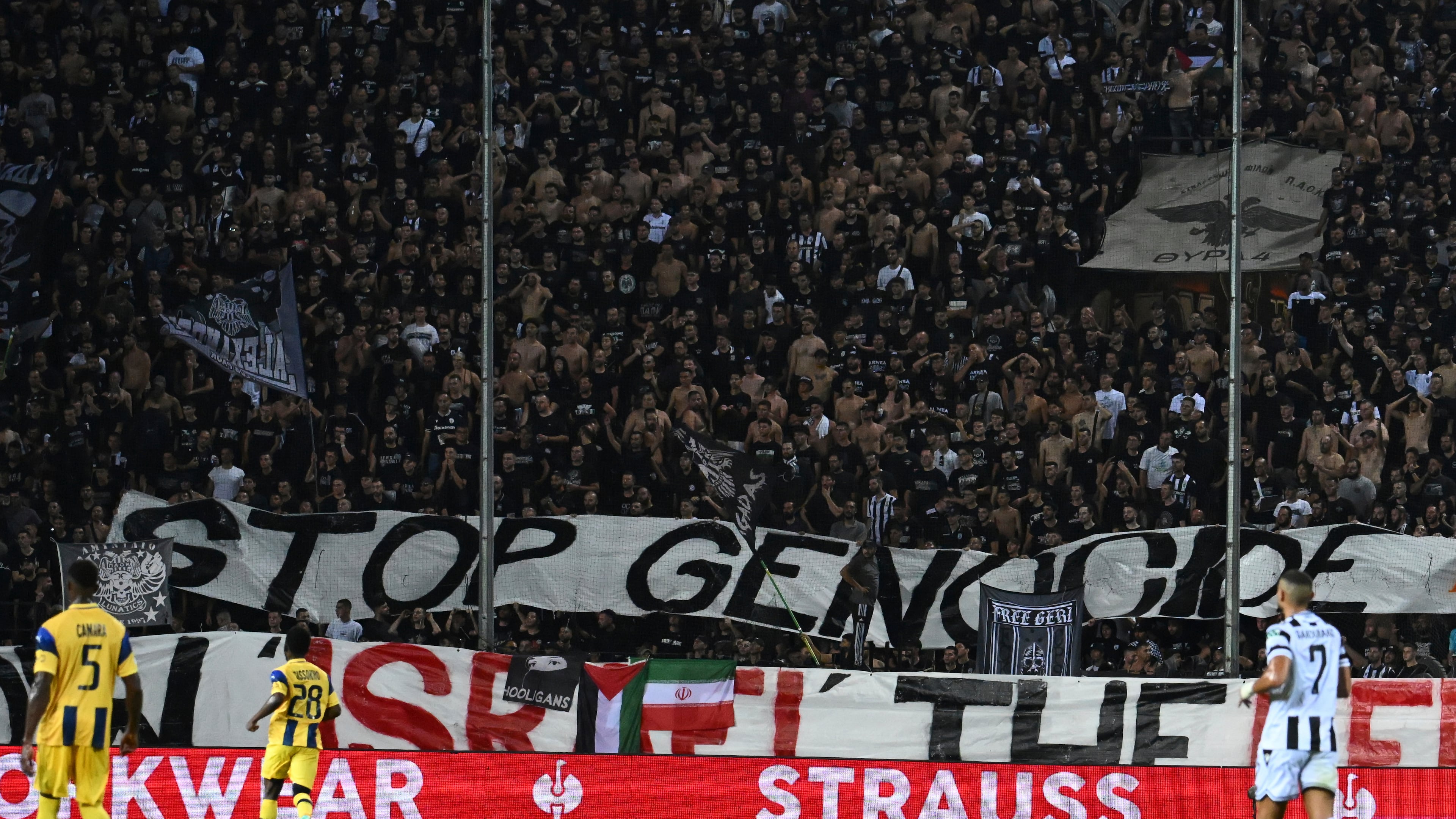 PAOK's fans display a banner that reads "stop genocide" during the Europa League soccer match between PAOK and Maccabi Tel Aviv at Toumpa stadium, in Thessaloniki, Greece, Wednesday, Sept. 24, 2025. (AP Photo/Giannis Papanikos)