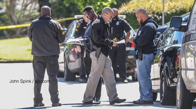 DeKalb police officials at the scene of a shooting last year. JOHN SPINK / JSPINK@AJC.COM