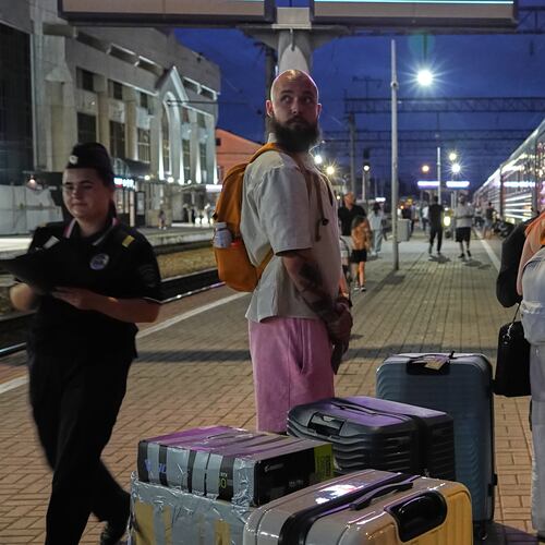 A 28-year-old digital content marketer who decided to leave Russia stands near his packed belongings at the railway station in Krasnodar, Russia, on Saturday, Aug. 29, 2026. He asked not to be identified because of security concerns. (AP Photo)