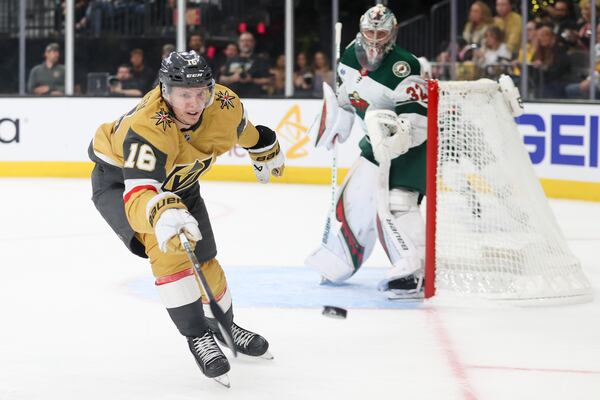 Vegas Golden Knights left wing Pavel Dorofeyev (16) skates after a loose puck while Minnesota Wild goaltender Filip Gustavsson (32) looks on during the second period in Game 1 of an NHL hockey Stanley Cup first-round playoff series Sunday, April 20, 2025, in Las Vegas. (AP Photo/Ian Maule)