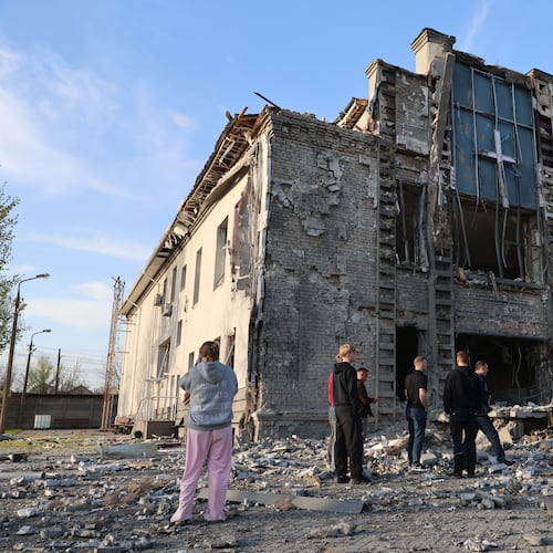 People stand outside a Baptist church damaged by a Russian guided aerial bomb, in Zaporizhzhia, Ukraine, Thursday, April 16, 2026. (AP Photo/Kateryna Klochko)