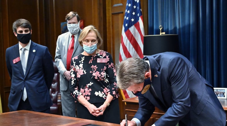 In June 2020, Gov. Brian Kemp signed House Bill 987, the senior care reform bill, into law as (from left) Rep. John LaHood (R-Valdosta), Joe Hood of the Georgia Department of Community Health, and Rep. Sharon Cooper (R-Marietta) watched at Georgia State Capitol. (Hyosub Shin / Hyosub.Shin@ajc.com)