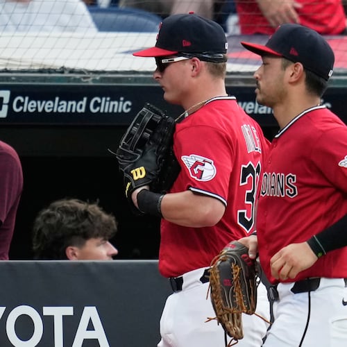 Cleveland Guardians left fielder Cooper Ingle, left, runs in from the outfield with center fielder Steven Kwan, right, after the first half of the seventh inning of a baseball game against the Texas Rangers in Cleveland, Tuesday, June 30, 2026. (AP Photo/Sue Ogrocki)