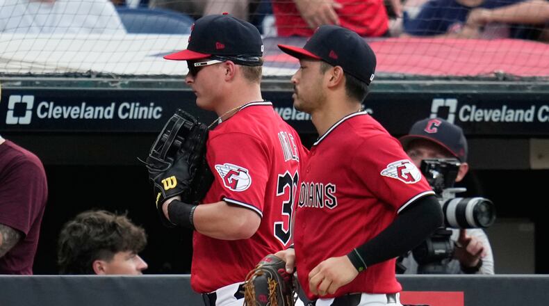 Cleveland Guardians left fielder Cooper Ingle, left, runs in from the outfield with center fielder Steven Kwan, right, after the first half of the seventh inning of a baseball game against the Texas Rangers in Cleveland, Tuesday, June 30, 2026. (AP Photo/Sue Ogrocki)