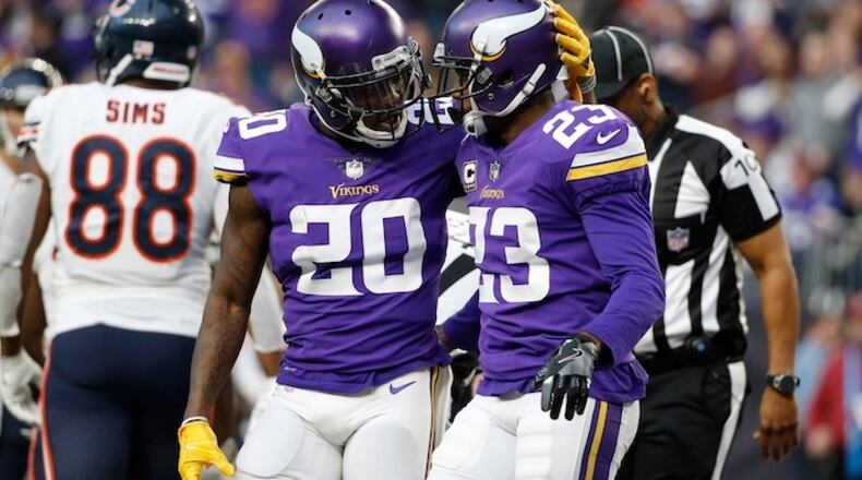 Minnesota Vikings cornerback Mackensie Alexander (20) celebrates with teammate Terence Newman (23) during the second half of an NFL football game against the Chicago Bears, Sunday, Dec. 31, 2017, in Minneapolis. (AP Photo/Bruce Kluckhohn)
