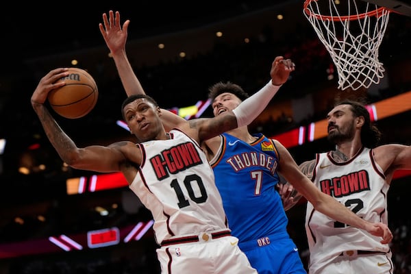Houston Rockets forward Jabari Smith Jr. (10) reaches for a rebound against Oklahoma City Thunder forward Chet Holmgren (7) during the first half of an NBA basketball game in Houston, Friday, April 4, 2025. (AP Photo/Ashley Landis)