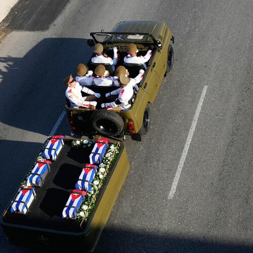 A motorcade transports urns containing the remains of Cuban officers, who were killed during the U.S. operation in Venezuela that captured Venezuelan President Nicolas Maduro, through Havana, Cuba, Thursday, Jan. 15, 2026. (AP Photo/Ramon Espinosa)