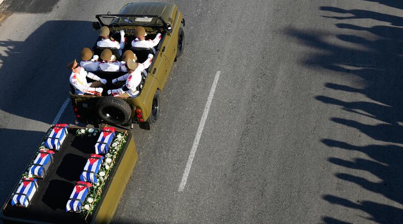 A motorcade transports urns containing the remains of Cuban officers, who were killed during the U.S. operation in Venezuela that captured Venezuelan President Nicolas Maduro, through Havana, Cuba, Thursday, Jan. 15, 2026. (AP Photo/Ramon Espinosa)