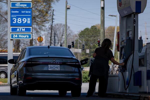 A driver fills up at a gas station on Powers Ferry Road in Marietta in March. (Ben Hendren for the AJC)