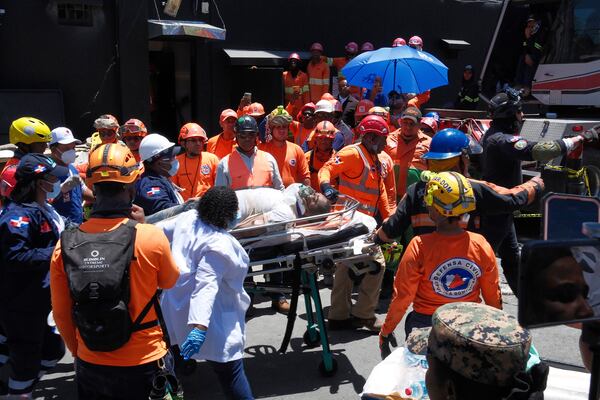 Rescue workers carry a person pulled from the wreckage of the Jet Set nightclub after its roof collapsed during a merengue concert in Santo Domingo, Dominican Republic, Tuesday, April 8, 2025. (AP Photo/Ricardo Hernandez)