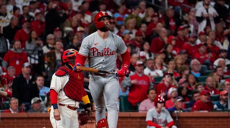 Philadelphia Phillies' Bryce Harper watches his solo home run against the St. Louis Cardinals during the second inning in Game 2 of an NL wild-card baseball playoff series Saturday, Oct. 8, 2022, in St. Louis. (AP Photo/Jeff Roberson)